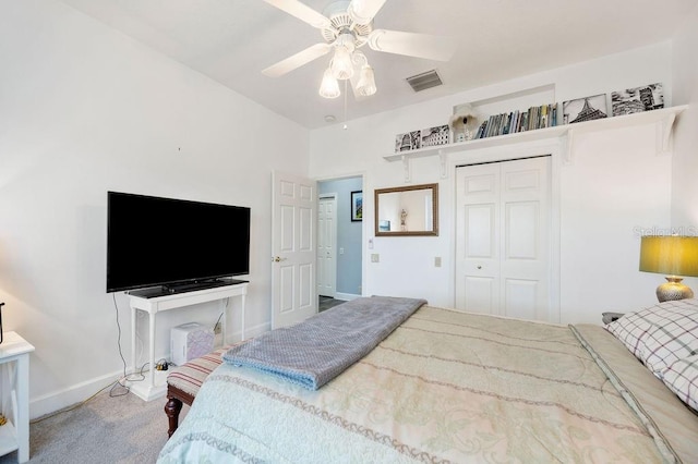 carpeted bedroom with ceiling fan and a closet