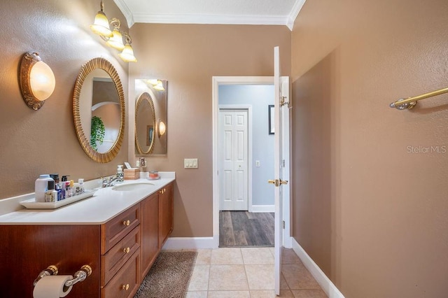 bathroom with tile patterned flooring, vanity, and crown molding