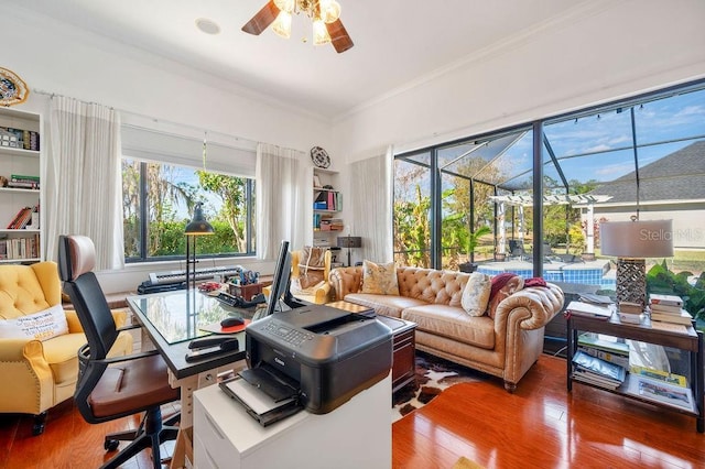 interior space featuring hardwood / wood-style flooring, ornamental molding, and ceiling fan