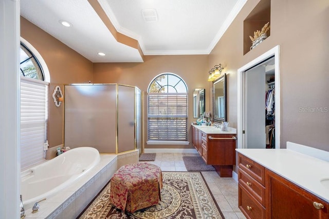 bathroom with vanity, ornamental molding, tile patterned floors, and shower with separate bathtub