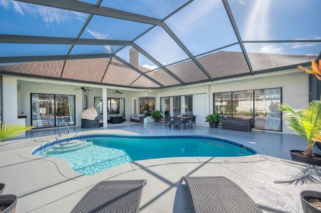 view of swimming pool featuring ceiling fan, an outdoor living space, a lanai, and a patio area