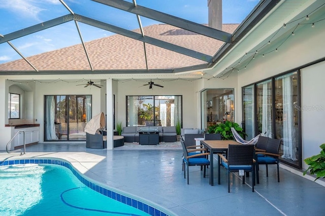 view of pool featuring a patio, an outdoor kitchen, an outdoor hangout area, and ceiling fan