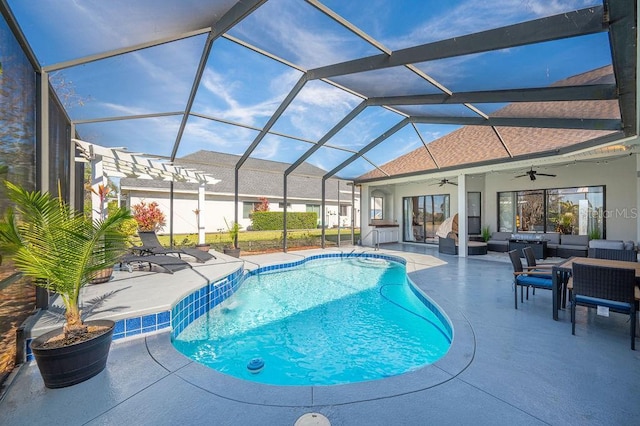 view of swimming pool featuring pool water feature, a lanai, ceiling fan, an outdoor hangout area, and a patio