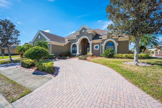 mediterranean / spanish house with a front lawn