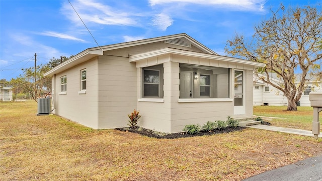 view of property exterior featuring central AC and a yard