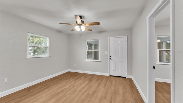 empty room with ceiling fan and light wood-type flooring