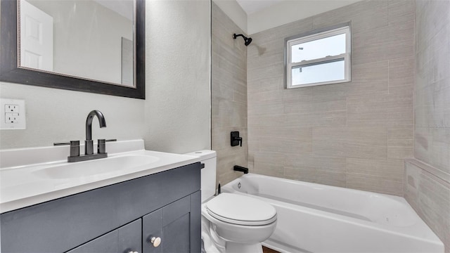 full bathroom featuring vanity, toilet, and tiled shower / bath combo