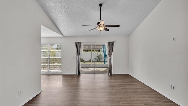 spare room featuring vaulted ceiling, ceiling fan, a textured ceiling, and dark hardwood / wood-style flooring