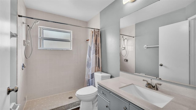 bathroom with walk in shower, vanity, and toilet