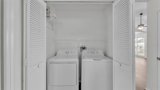 clothes washing area with hardwood / wood-style flooring, washer and dryer, and ceiling fan