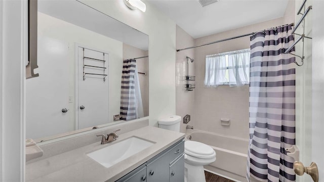 full bathroom with wood-type flooring, toilet, vanity, and shower / bath combination with curtain