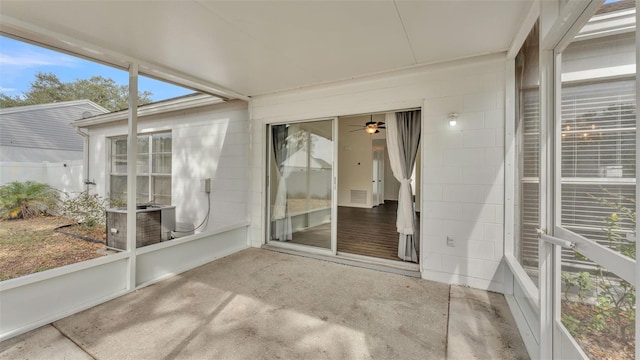 unfurnished sunroom featuring ceiling fan