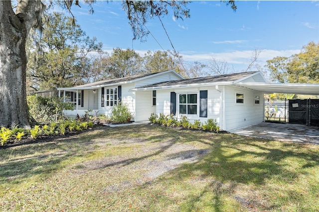 ranch-style home with a front lawn and a carport