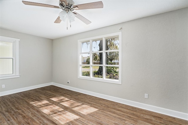 empty room featuring dark hardwood / wood-style floors and ceiling fan