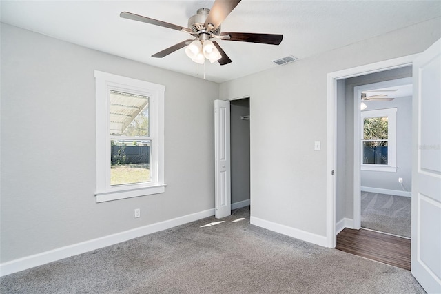 unfurnished bedroom with ceiling fan and carpet floors