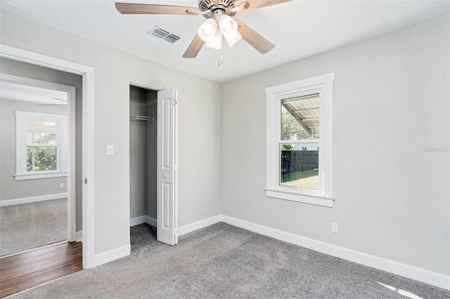 unfurnished bedroom with carpet, ceiling fan, and a closet