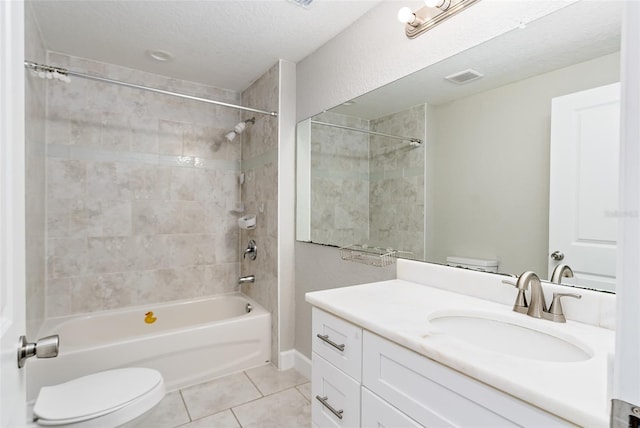 full bathroom with toilet, a textured ceiling, vanity, tiled shower / bath combo, and tile patterned flooring