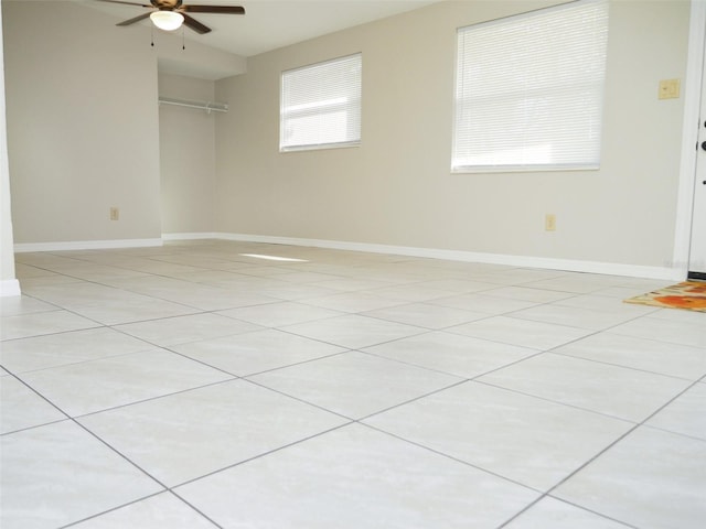 empty room with light tile patterned floors and ceiling fan