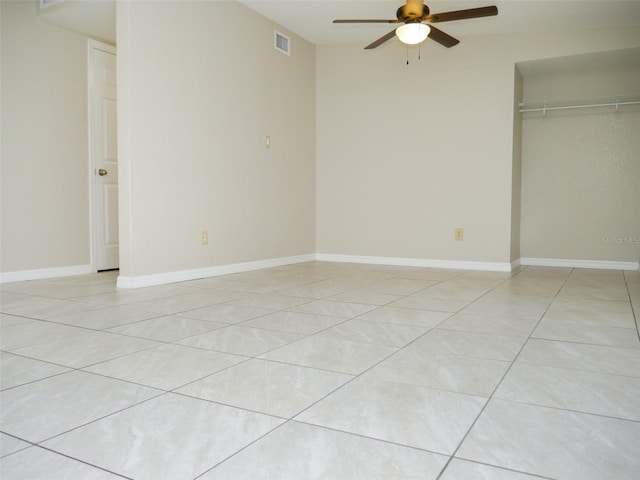 unfurnished bedroom with ceiling fan, a closet, and light tile patterned floors