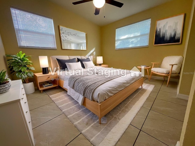 bedroom with ceiling fan and light tile patterned floors