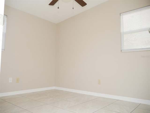 tiled empty room featuring ceiling fan