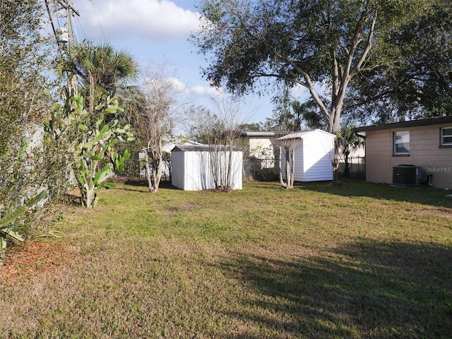 view of yard with cooling unit and a storage unit