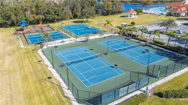 view of sport court featuring a gazebo and a water view