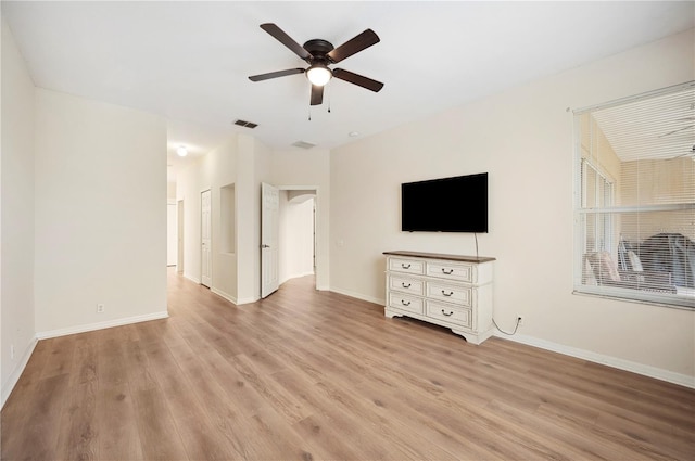 unfurnished living room featuring ceiling fan and light hardwood / wood-style floors