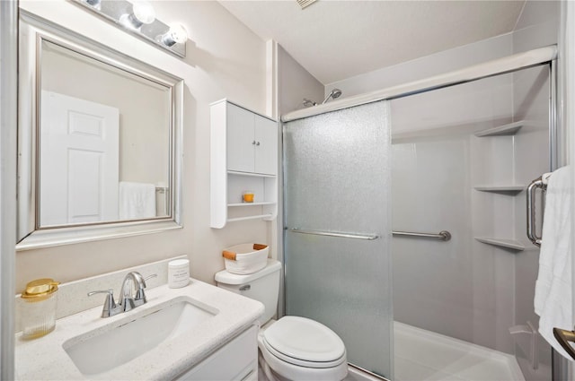 bathroom featuring an enclosed shower, vanity, and toilet