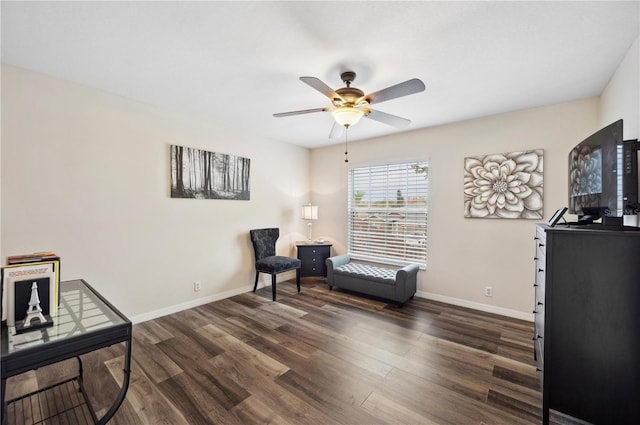 living area featuring ceiling fan and dark hardwood / wood-style flooring