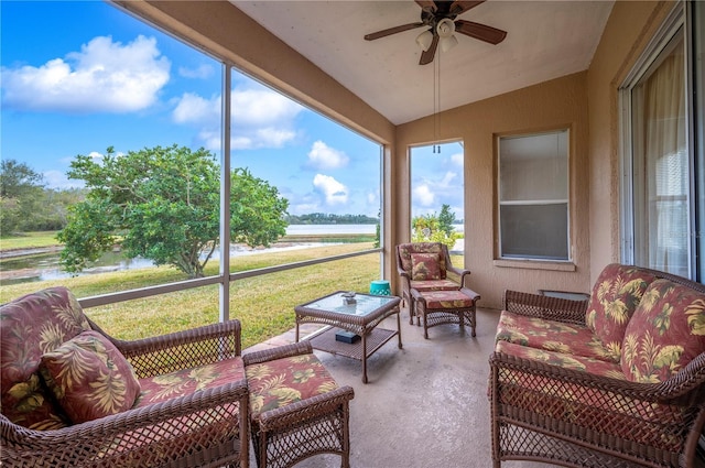 sunroom / solarium with a water view, lofted ceiling, and ceiling fan