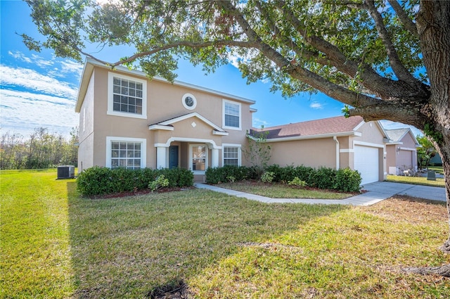 traditional-style home featuring a front lawn, central air condition unit, concrete driveway, an attached garage, and stucco siding