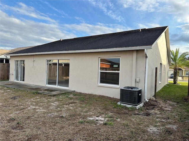 back of property with a patio area and central AC