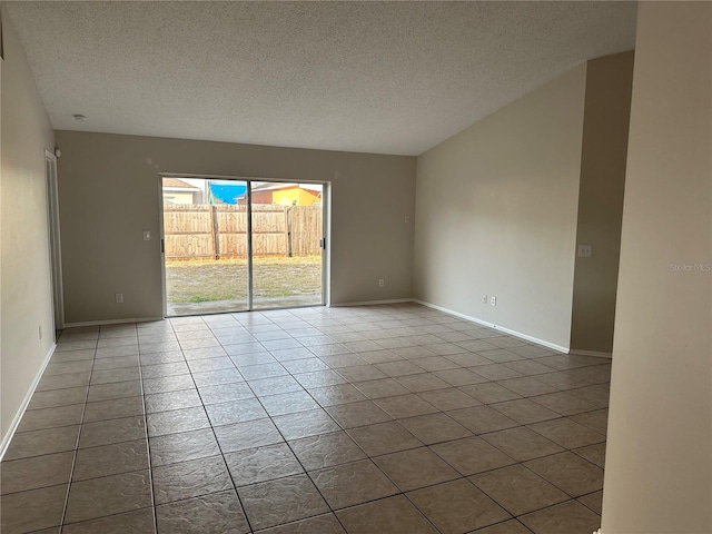 empty room featuring a textured ceiling and tile patterned floors