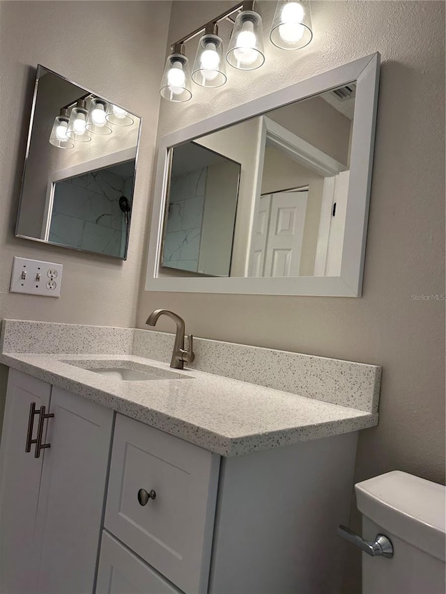 bathroom with toilet and vanity