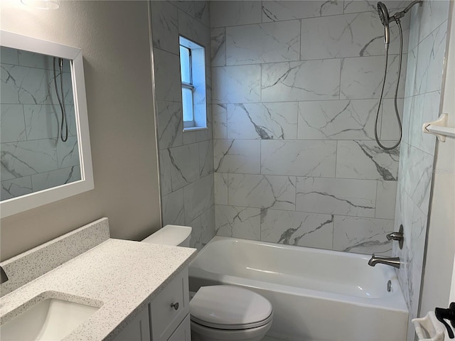 full bathroom featuring tiled shower / bath combo, vanity, and toilet