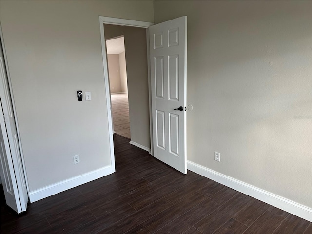 unfurnished bedroom featuring dark hardwood / wood-style floors