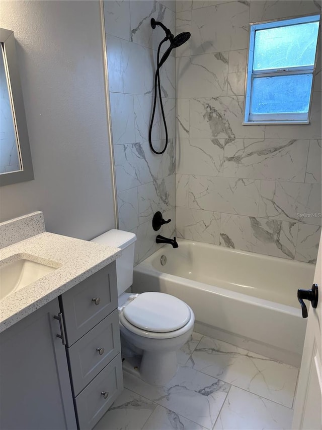 full bathroom featuring toilet, vanity, and tiled shower / bath combo