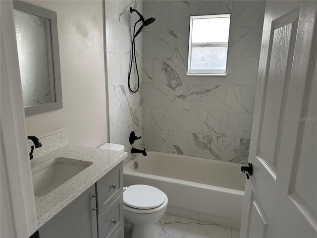 full bathroom featuring toilet, vanity, and tiled shower / bath combo