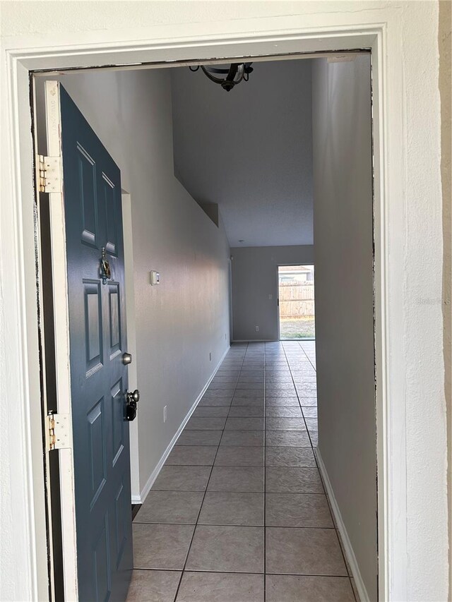 corridor featuring dark tile patterned flooring