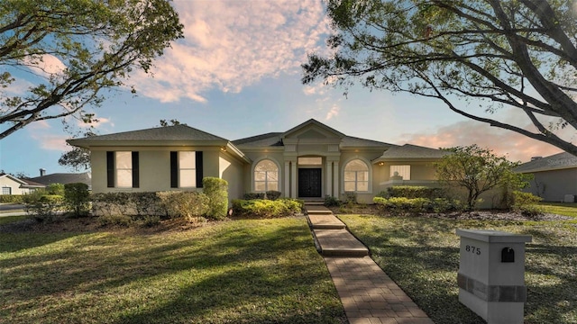 view of front of home with a lawn