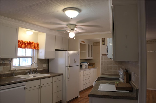 kitchen with tasteful backsplash, white appliances, sink, and white cabinets