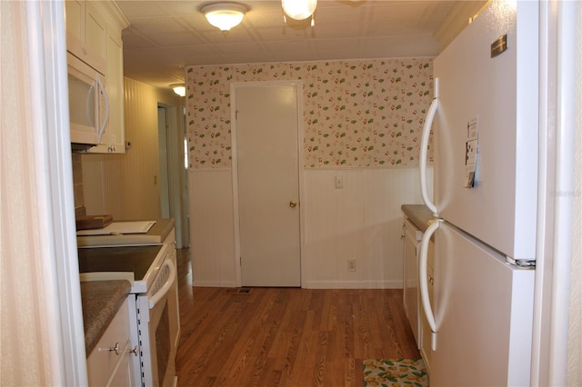 kitchen with light wood-type flooring, white cabinets, and white appliances