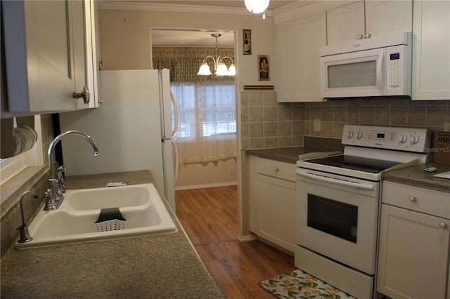 kitchen with wood-type flooring, sink, white cabinets, ornamental molding, and white appliances