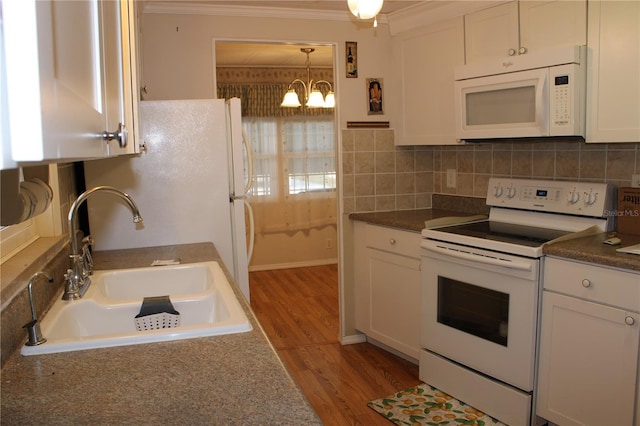 kitchen with white cabinetry, sink, backsplash, crown molding, and white appliances