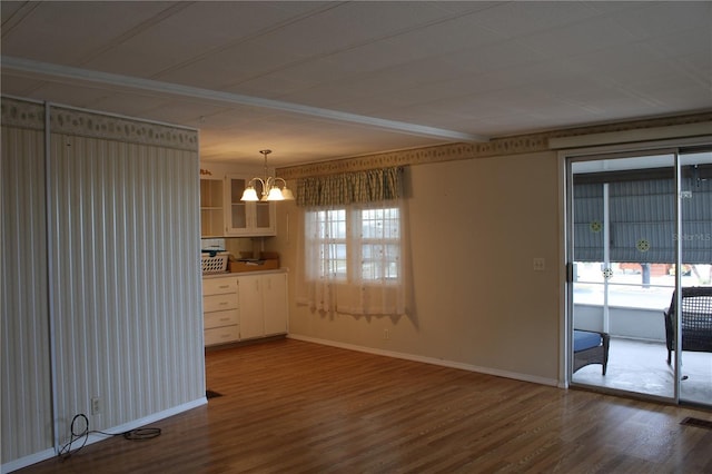 interior space with hardwood / wood-style floors and a notable chandelier