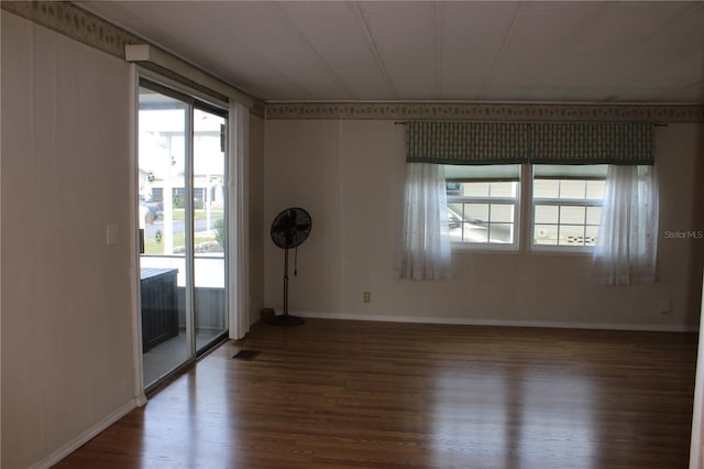 unfurnished room with hardwood / wood-style flooring