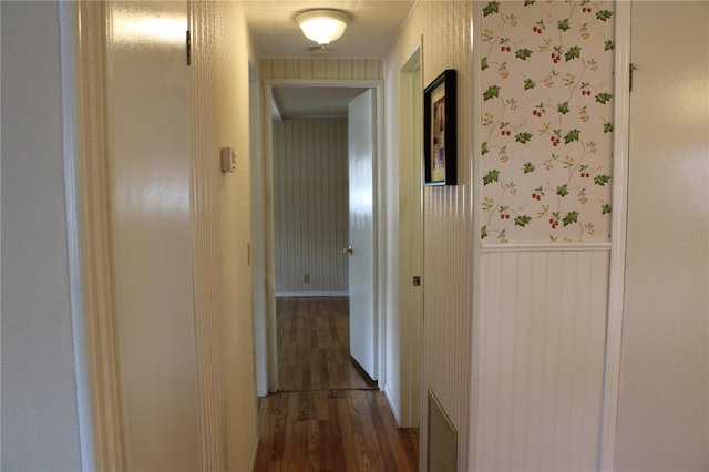 corridor with dark hardwood / wood-style flooring