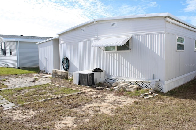 rear view of house featuring central air condition unit