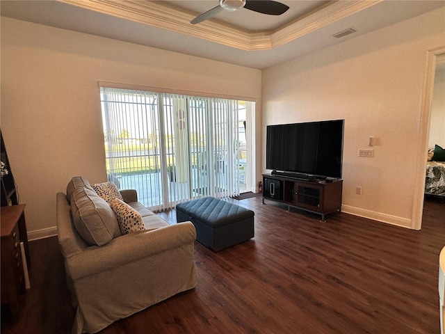 living room featuring crown molding, ceiling fan, a tray ceiling, and dark hardwood / wood-style flooring